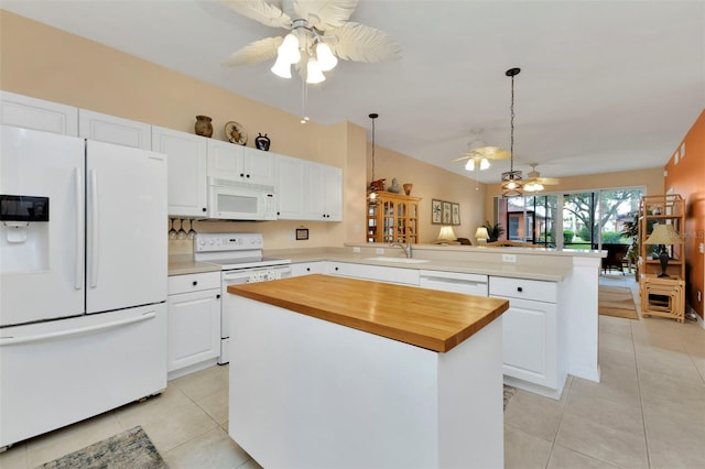 kitchen with kitchen peninsula, white appliances, and white cabinetry