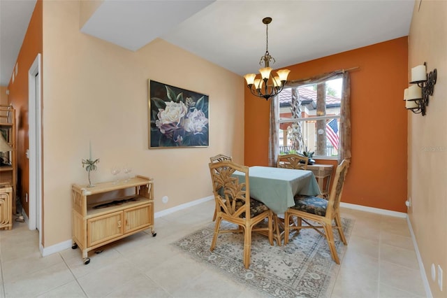 tiled dining room featuring a notable chandelier