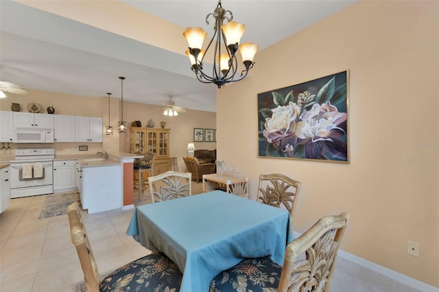 tiled dining room featuring ceiling fan with notable chandelier and sink