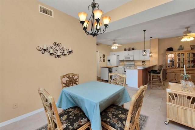 dining area with light tile patterned floors and ceiling fan with notable chandelier