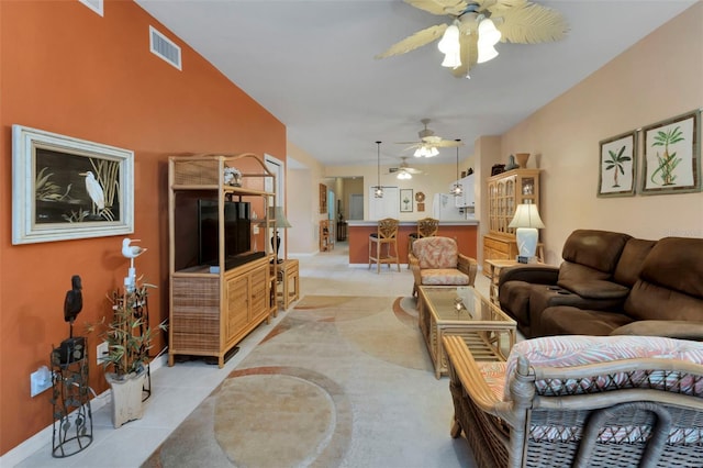 living room featuring ceiling fan and light tile patterned floors