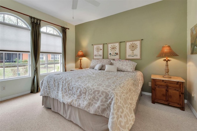 bedroom with ceiling fan and light carpet