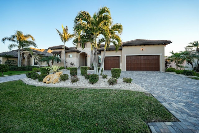 view of front of house with a front lawn and a garage