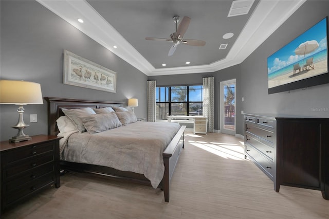 bedroom with ceiling fan, light wood-type flooring, ornamental molding, and a raised ceiling