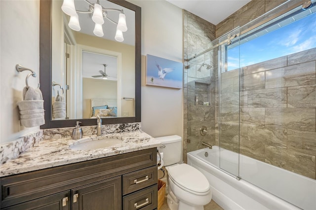 full bathroom featuring enclosed tub / shower combo, vanity, and toilet