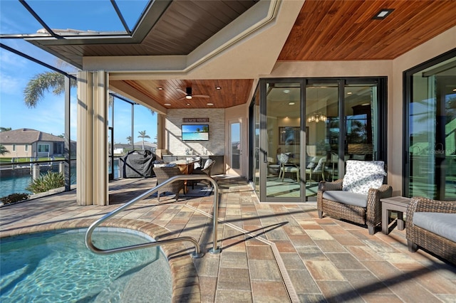 exterior space featuring ceiling fan and glass enclosure