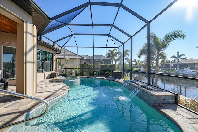 view of swimming pool with an in ground hot tub, pool water feature, a water view, a lanai, and a patio