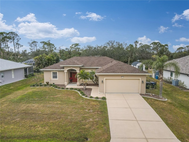 view of front of house with central AC unit, a garage, and a front lawn