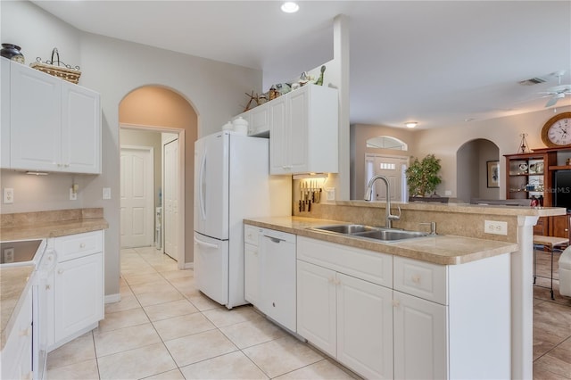 kitchen featuring kitchen peninsula, white appliances, ceiling fan, sink, and white cabinets