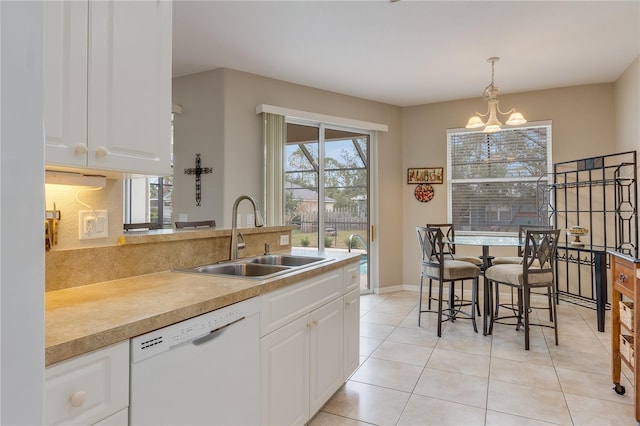 kitchen featuring dishwasher, a notable chandelier, white cabinets, sink, and decorative light fixtures