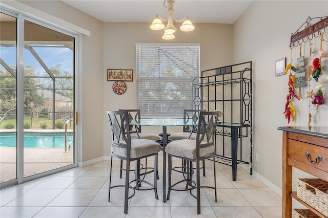 tiled dining room featuring a notable chandelier