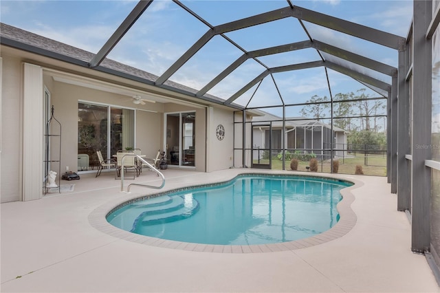 view of swimming pool featuring a patio, ceiling fan, and a lanai