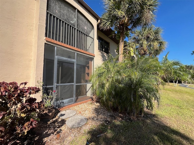 view of side of home with a yard