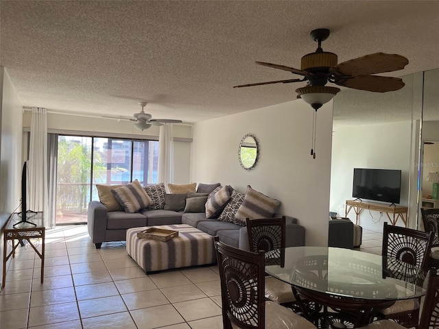 tiled living room with a textured ceiling and ceiling fan