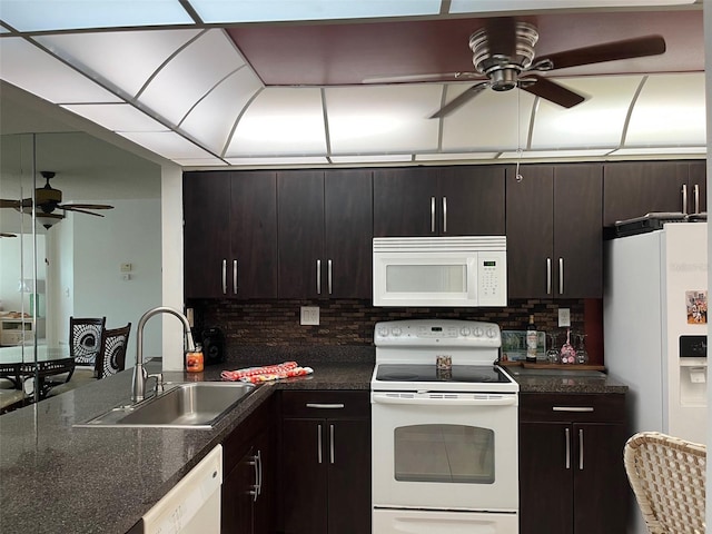 kitchen featuring ceiling fan, white appliances, dark brown cabinetry, and sink