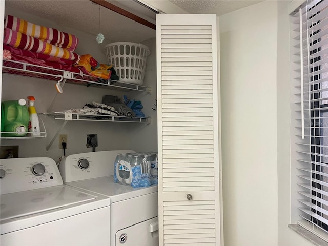 washroom featuring washer and dryer and a textured ceiling