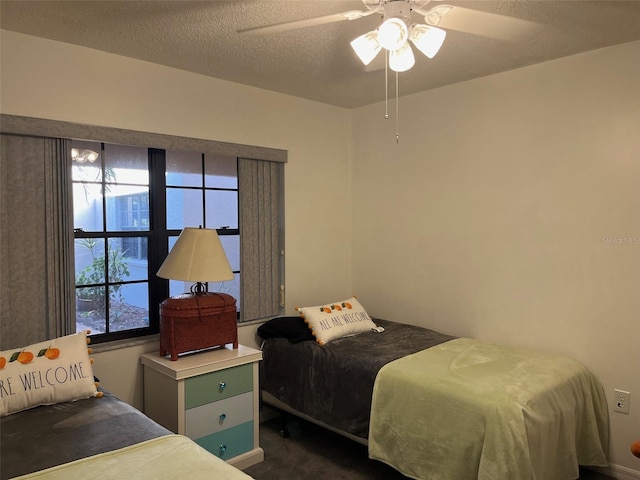 carpeted bedroom with multiple windows, a textured ceiling, and ceiling fan