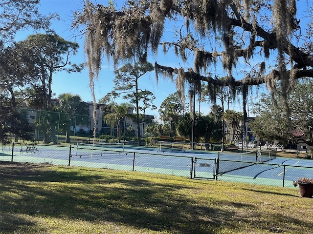 view of sport court featuring a yard