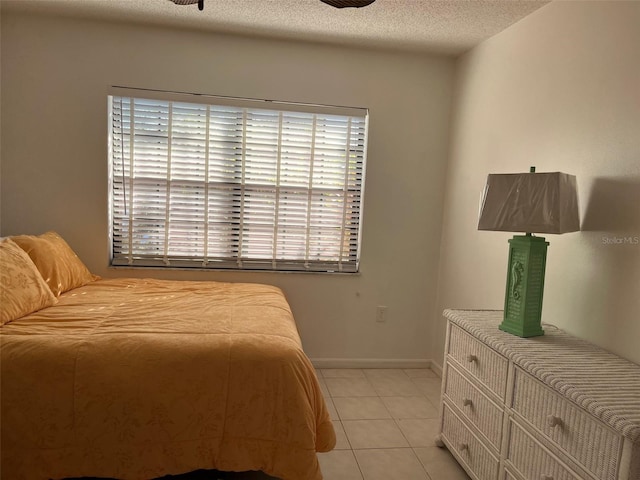 tiled bedroom featuring a textured ceiling