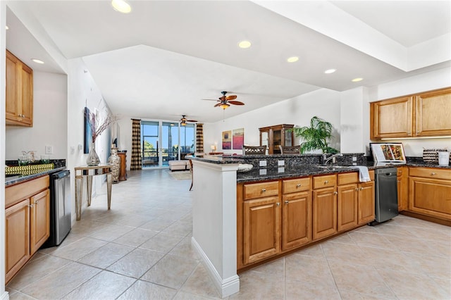 kitchen featuring kitchen peninsula, dark stone counters, ceiling fan, and stainless steel dishwasher