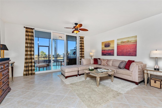 living room with floor to ceiling windows, ceiling fan, and light tile patterned floors