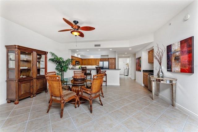 dining room featuring ceiling fan and light tile patterned floors