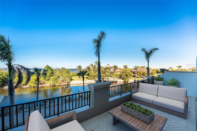 exterior space featuring a balcony, a water view, and an outdoor hangout area