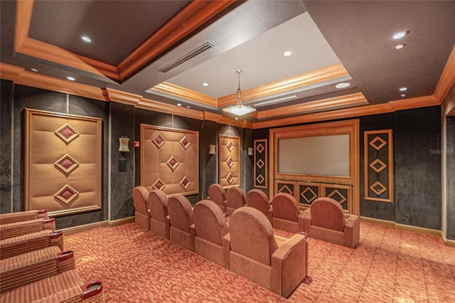 cinema featuring light colored carpet, crown molding, and a tray ceiling