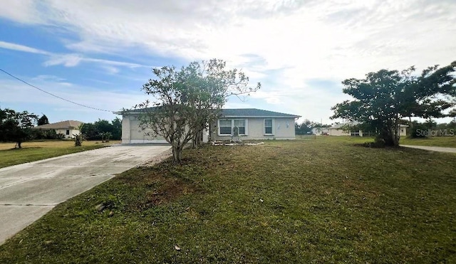 ranch-style house with a front yard, concrete driveway, and an attached garage