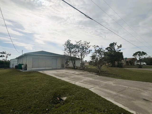 exterior space with driveway and a front yard