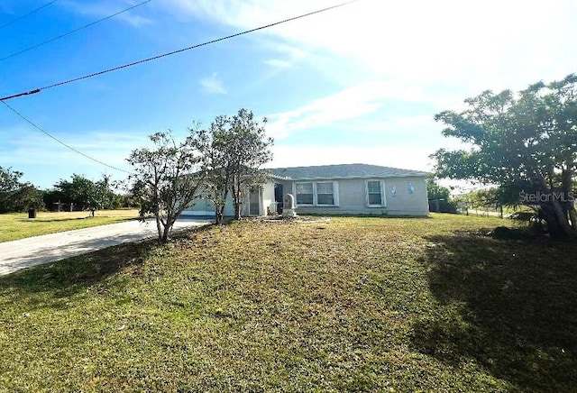 view of front of home with a front yard and driveway