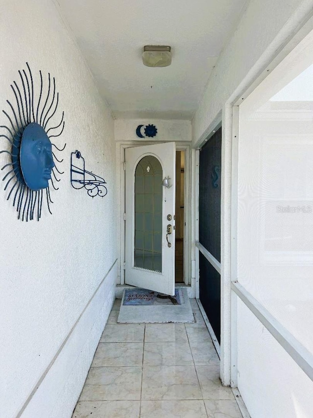 doorway to property with stucco siding