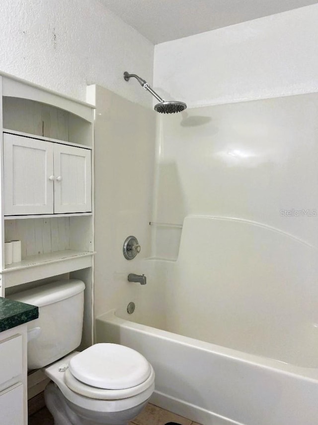 bathroom featuring toilet, shower / bath combination, vanity, and tile patterned floors