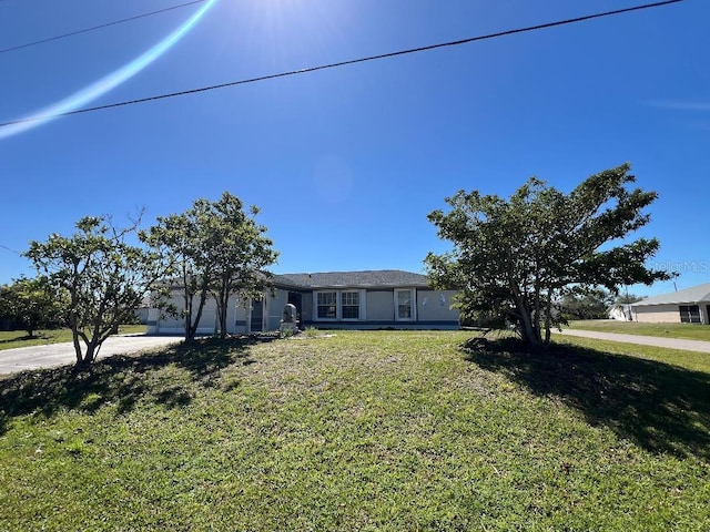 ranch-style home with a garage, concrete driveway, and a front yard