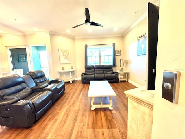 living room with ceiling fan, plenty of natural light, crown molding, and hardwood / wood-style flooring