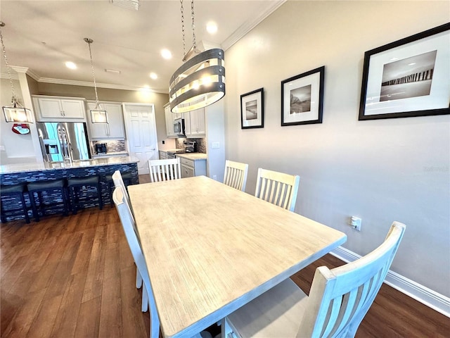 dining area with dark hardwood / wood-style floors and crown molding