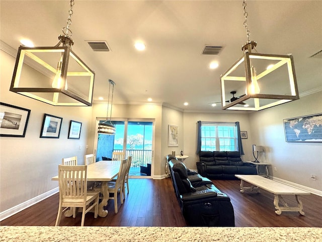 dining space with dark hardwood / wood-style flooring, plenty of natural light, and ornamental molding