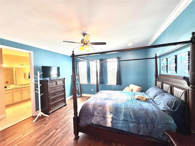 bedroom featuring ceiling fan, hardwood / wood-style floors, ensuite bathroom, and ornamental molding