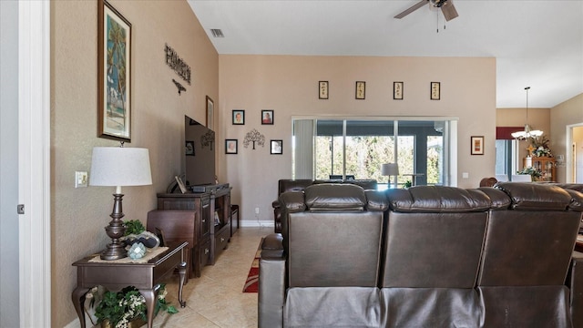 living room featuring light tile patterned floors, vaulted ceiling, and ceiling fan with notable chandelier