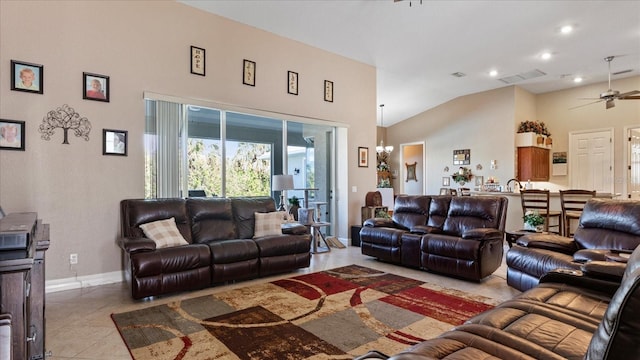 tiled living room with lofted ceiling and ceiling fan with notable chandelier