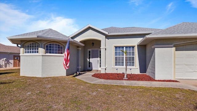 view of front facade with a garage and a front lawn