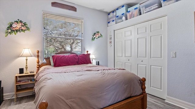 bedroom with a closet and light hardwood / wood-style floors