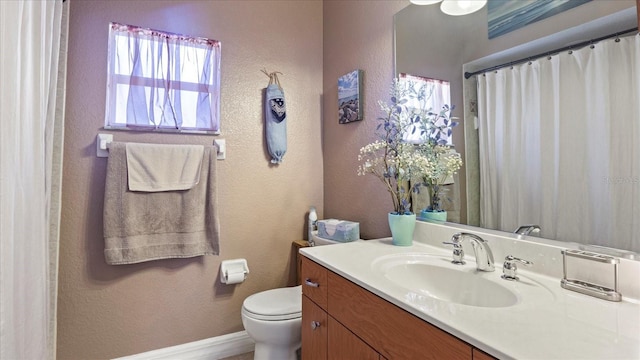 bathroom with toilet and vanity