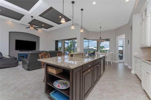 kitchen featuring white cabinetry, dark brown cabinets, coffered ceiling, and decorative light fixtures