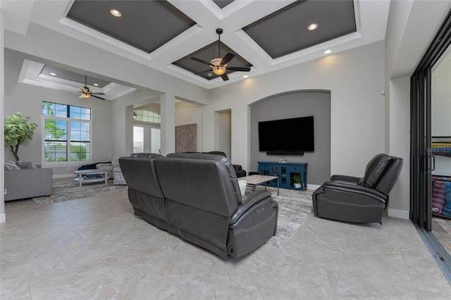 living room with ceiling fan, beam ceiling, a high ceiling, and coffered ceiling