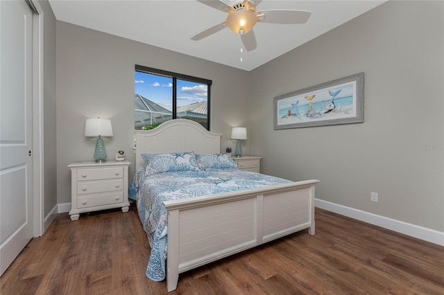 bedroom featuring dark wood-type flooring, ceiling fan, and a closet