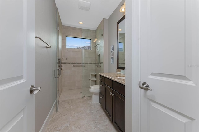 bathroom featuring toilet, an enclosed shower, and vanity