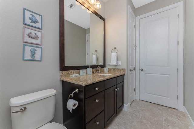 bathroom featuring toilet and vanity