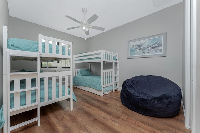 bedroom with ceiling fan and hardwood / wood-style floors