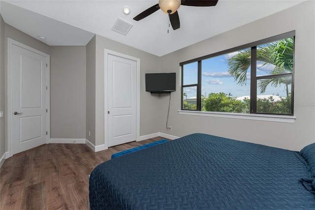 bedroom with ceiling fan and dark hardwood / wood-style floors